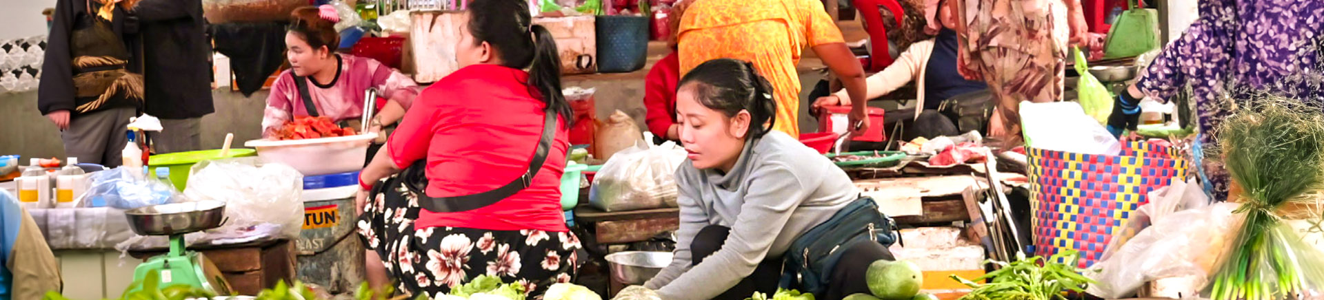 Women working at busy market.